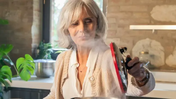 A woman's hands in warm kitchen light, holding onto what matters
