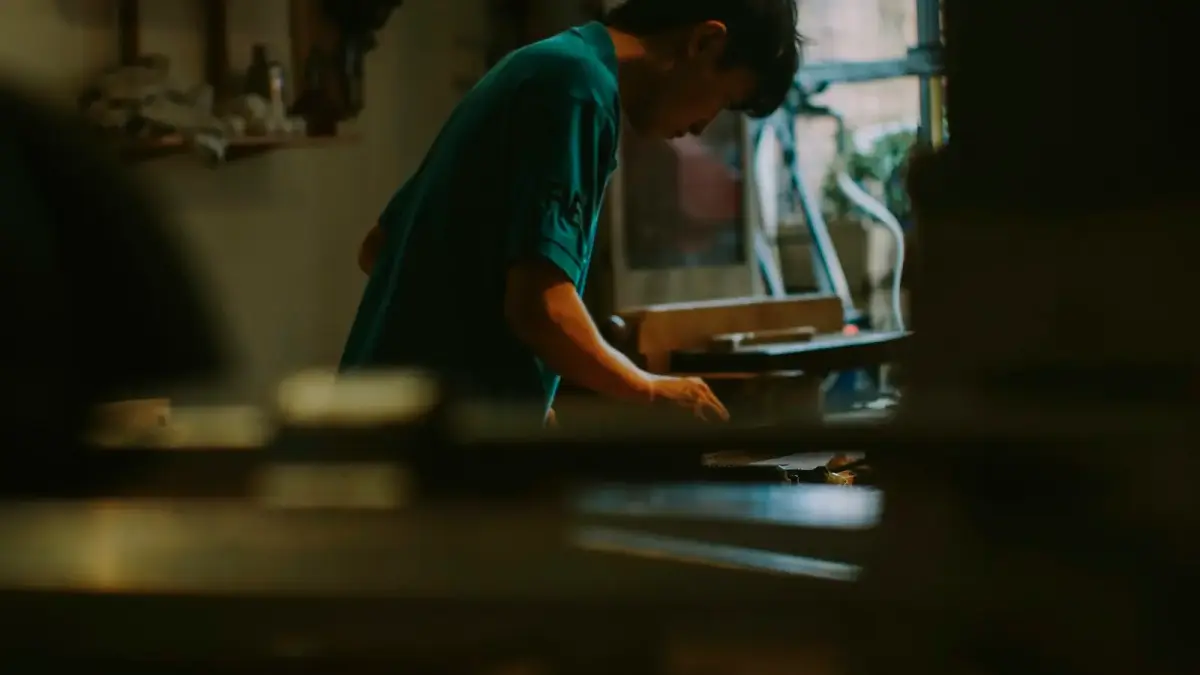 Young person working at a desk with books.