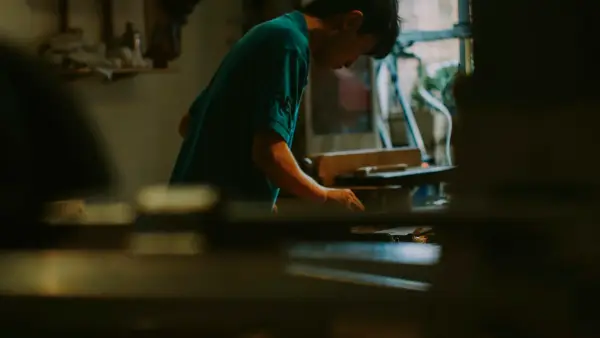 Young person working at a desk with books.