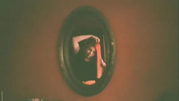 woman wearing black shirt on mirror