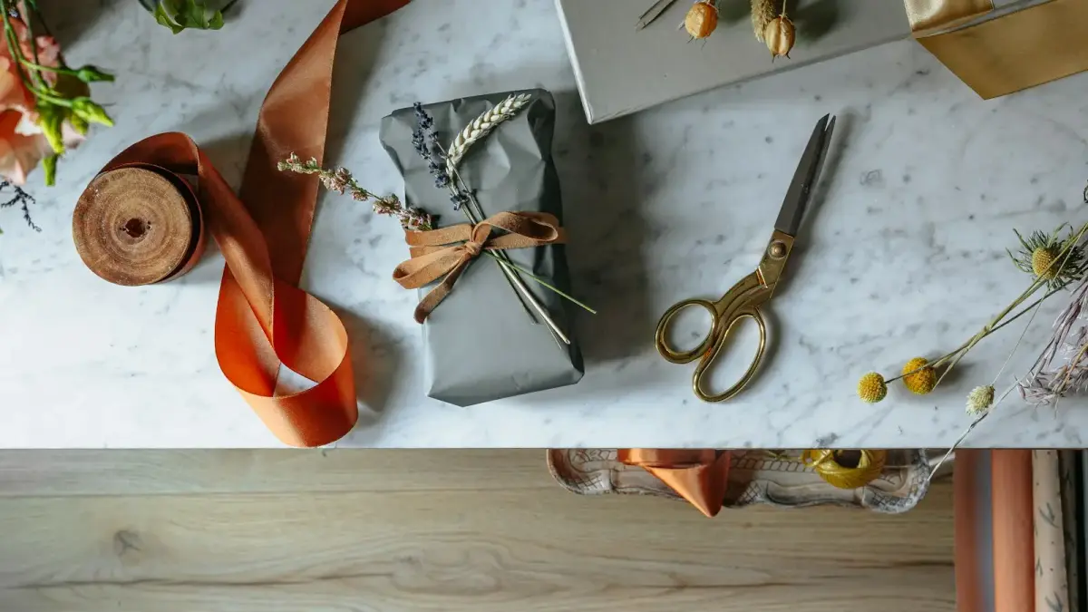 silver scissors beside orange leather shoe