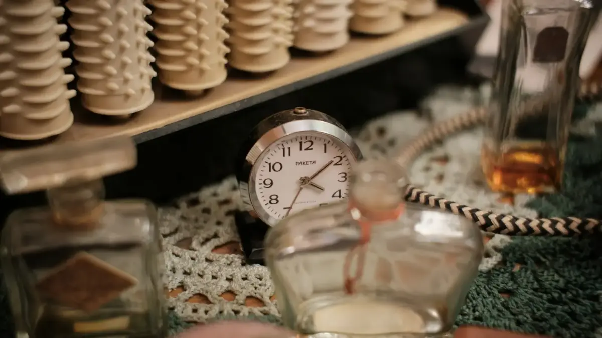 Vintage hair rollers, perfume bottles, and alarm clock.